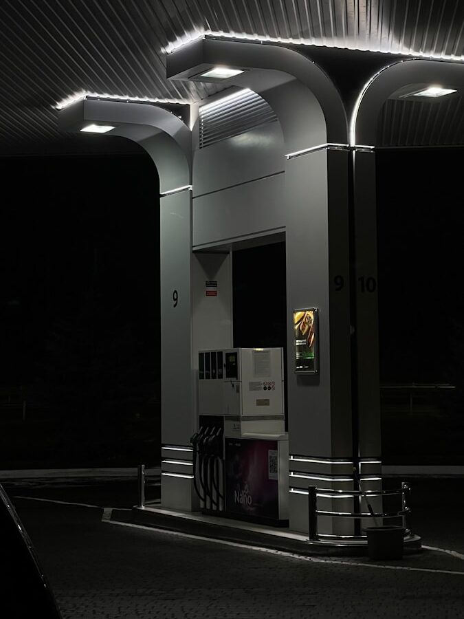 a gas station at night with lights on